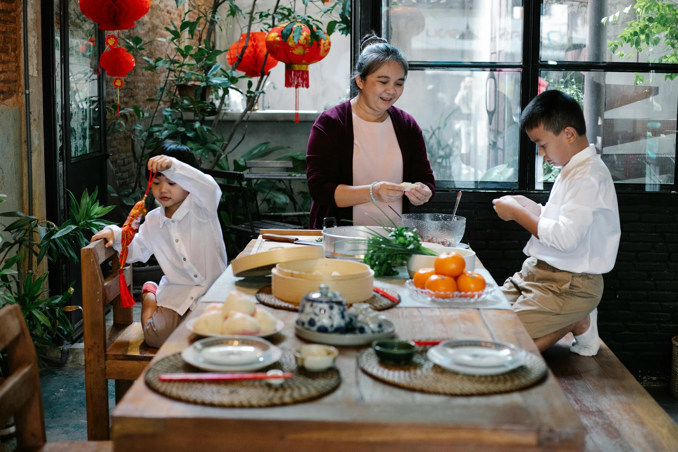 A grandmother and two children preparing food together
